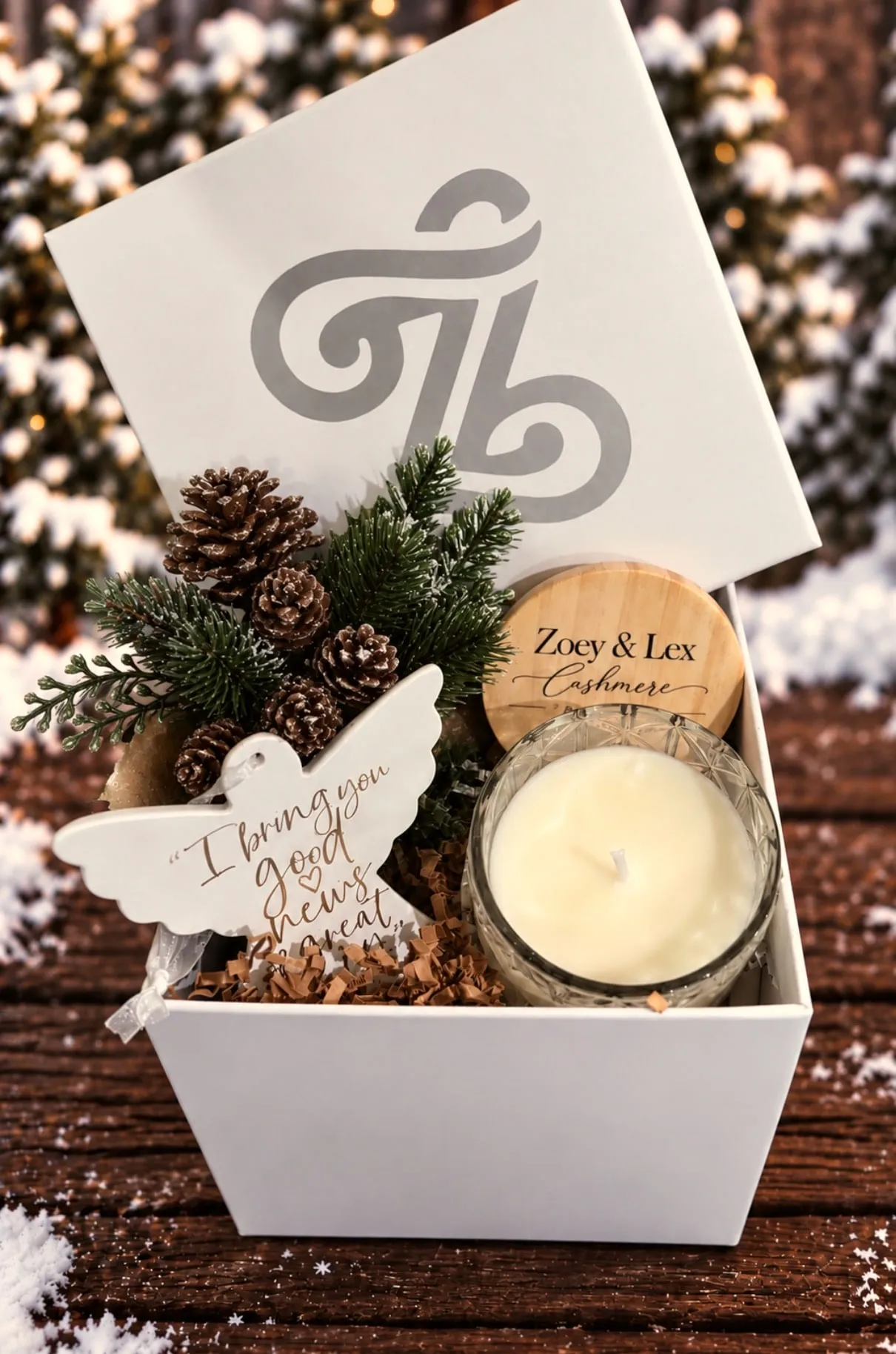 Cashmere soy candle and a dove ornament in a gift box with pinecones, a Christmas gift for mom