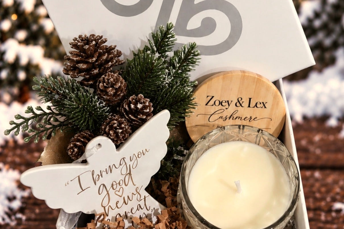 Cashmere soy candle and a dove ornament in a gift box with pinecones, a Christmas gift for mom
