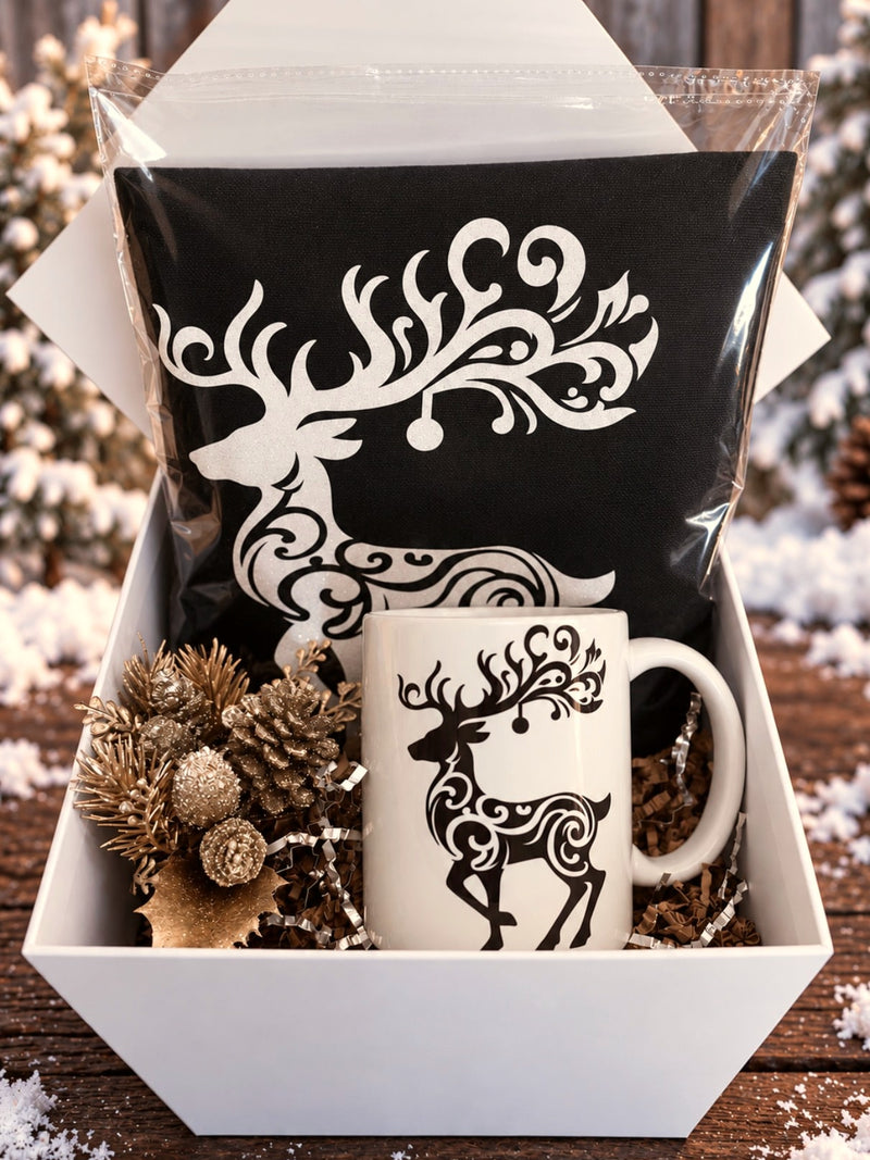 Black reindeer tote and matching mug in a white gift box with gold pinecones